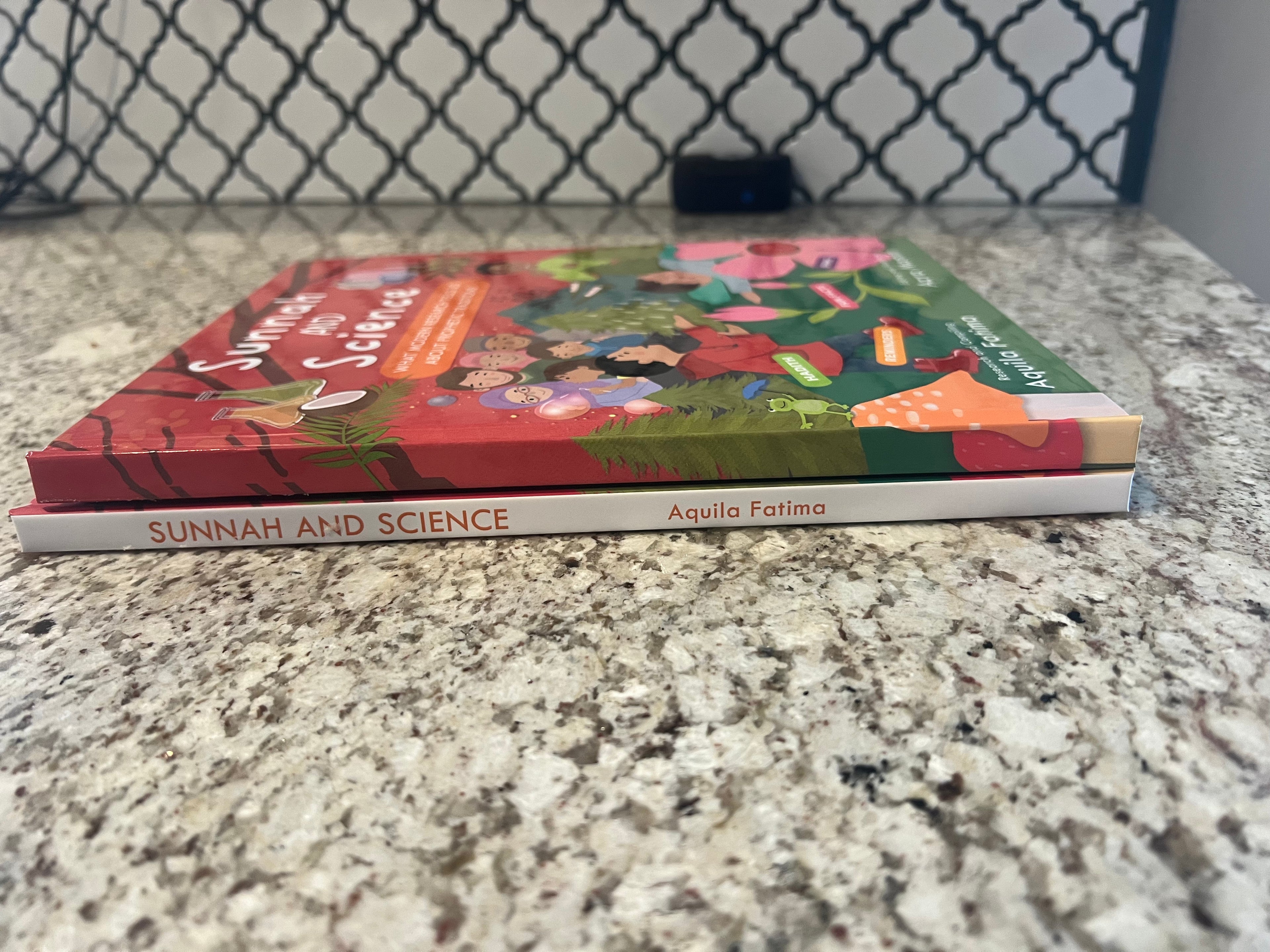 two sunnah and science books stacked on top of each other
