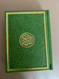 an emerald green quran with gold trim covers in a beautiful, detailed design