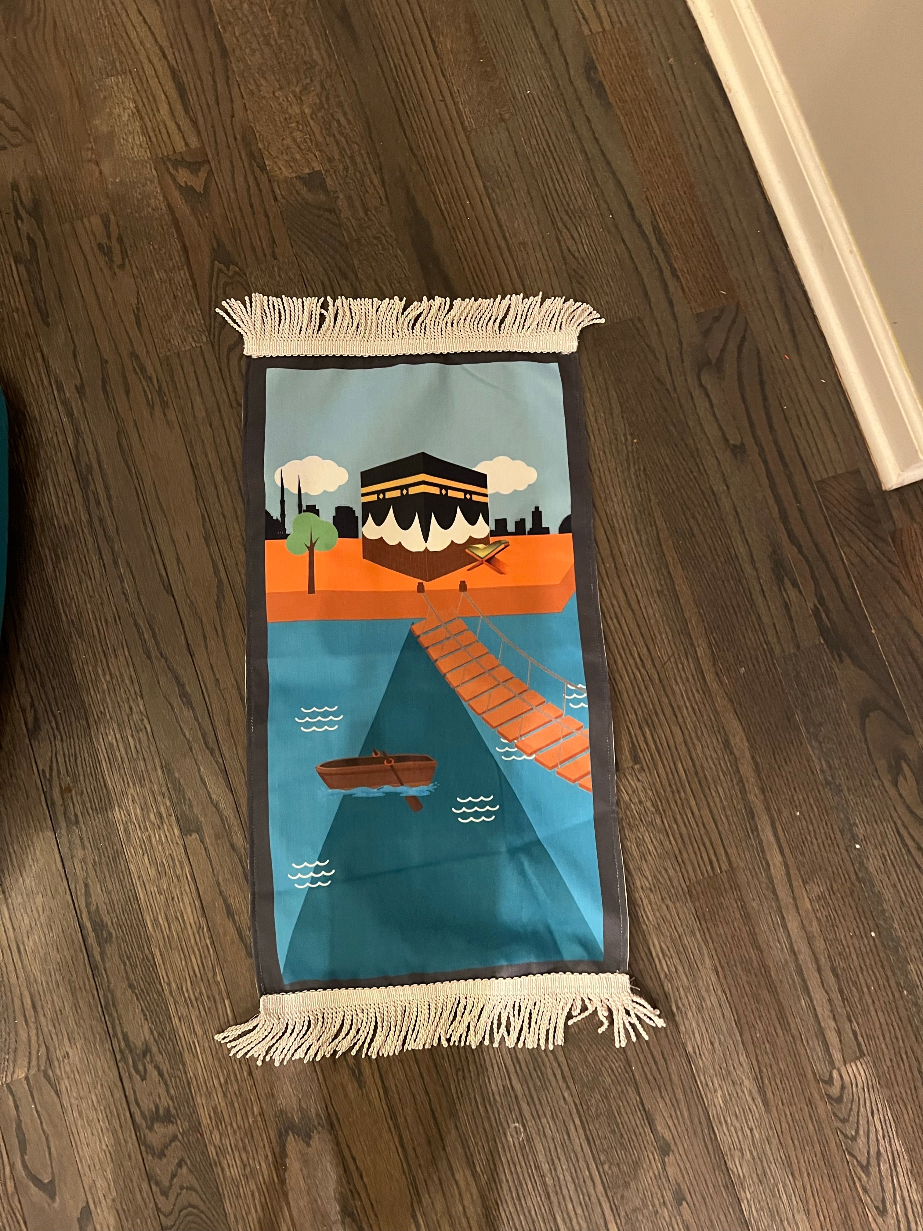 a grey bordered rug with orange and blue