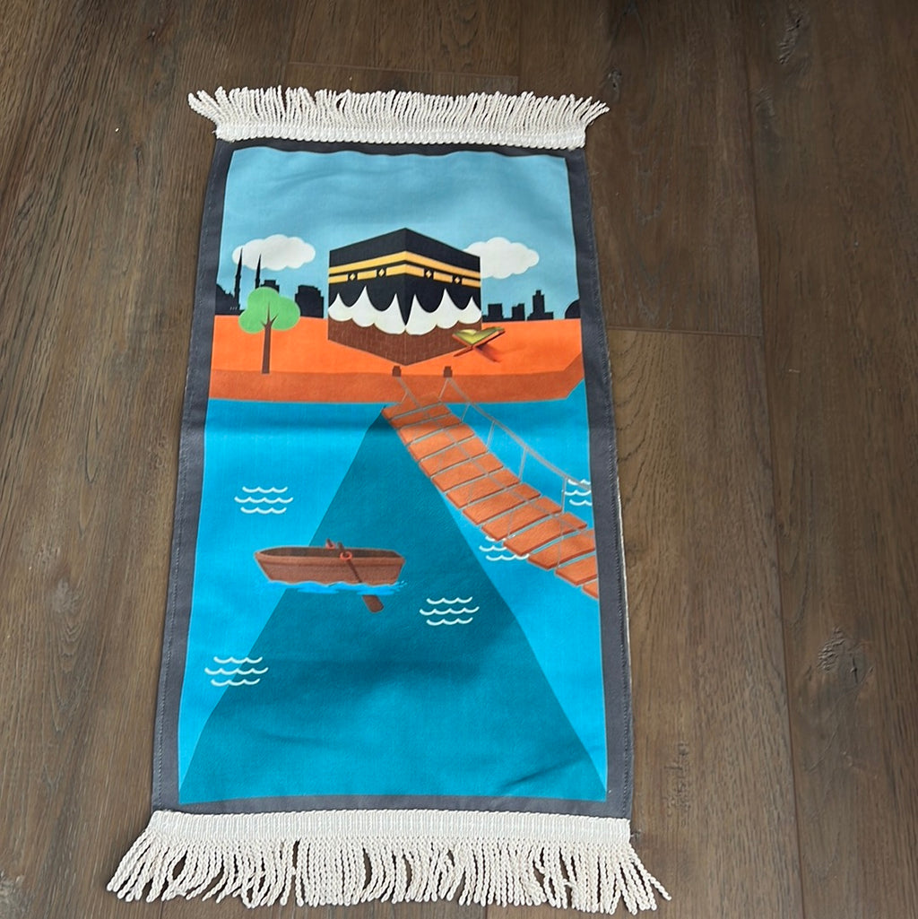 a far shot of the prayer rug with a Kaaba and dark blue border